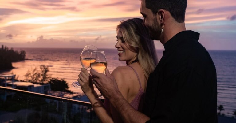 A couple spending time together and tossing a champagne glass with the romantic sunset vibe.